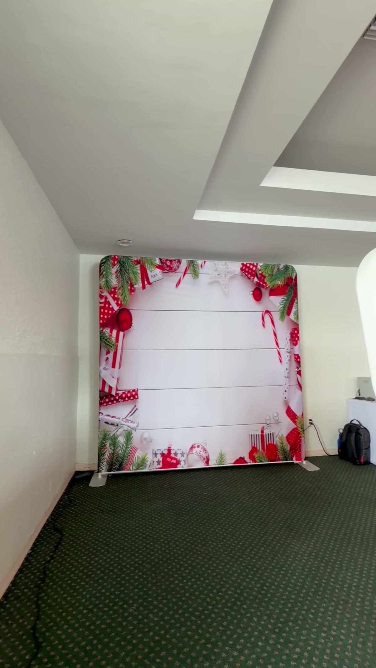A printed backdrop set up in a venue before guests arrive